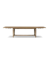A rectangular dining table with a solid oak base and a warm oak veneer tabletop.