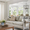 Light grey couch on top of 100% wool rug with antiqued warm tones