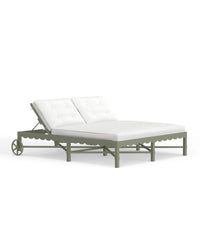 A Riviera Double Chaise Lounge with a scalloped back in Sage green with white cushions on a clear background.