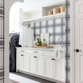 Mudroom with plaid wallpaper and a blue and ivory striped cotton runner
