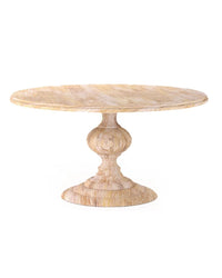 A round, white washed farmhouse dining table with a turned mango wood pedestal base.