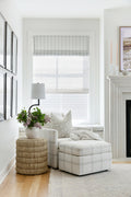 Oversized plaid chair on beige and pale blue rug