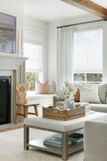 Living room with light grey couch on beige and pale blue rug