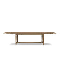 A rectangular dining table with a solid oak base and a warm oak veneer tabletop.