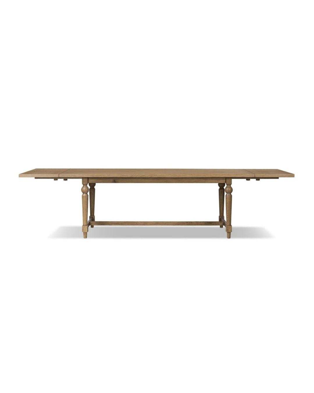 A rectangular dining table with a solid oak base and a warm oak veneer tabletop.