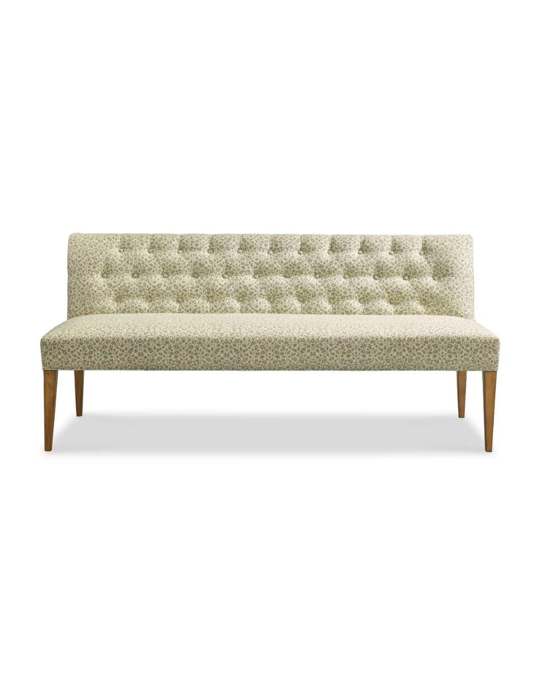 An upholstered bench with a tufted back, featuring a moss green fabric and a driftwood finish wood frame.