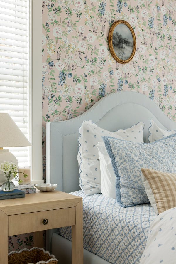 Bedroom with floral wallpaper, light blue headboard, and decorative pillows.