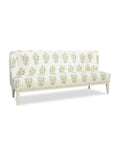 An upholstered banquette with a wood base, featuring a beige fabric with a green floral pattern.
