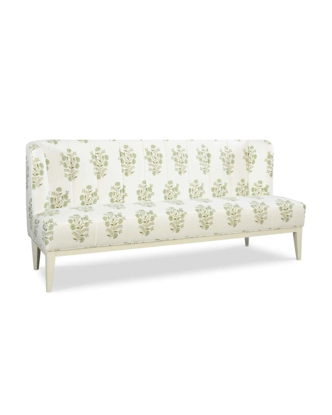 An upholstered banquette with a wood base, featuring a beige fabric with a green floral pattern.