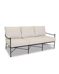 An Emmeline Collection sofa with a wrought iron frame and beige cushions, designed for outdoor use.