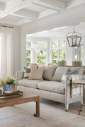 Light grey couch on top of 100% wool rug with antiqued warm tones