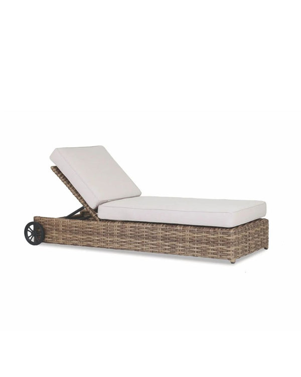 A modern outdoor chaise lounge with a woven resin wicker frame and a beige plush cushion, featuring adjustable backrest and wheels for mobility.