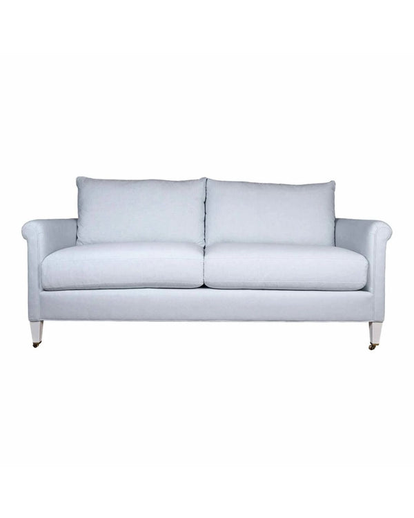A white high-arm sofa with traditional detailing and upholstery, pictured on a white background.