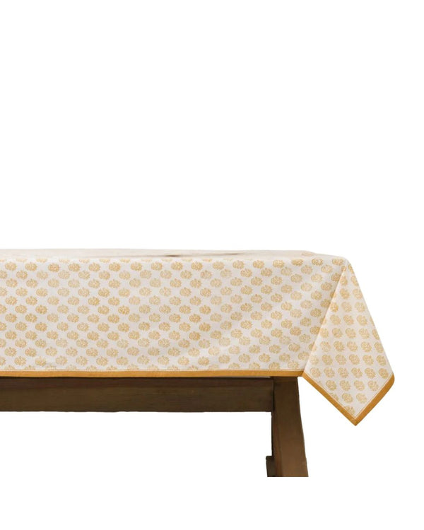 A rectangular tablecloth with a geometric pattern, predominantly white with orange accents, displayed on a table.
