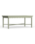 A rectangular outdoor coffee table with scalloped edge details, painted in a sage green color, with visible wooden frame and supporting legs.