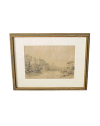 A vintage art print depicting a park scene with trees and a building, framed in a beige wooden frame.