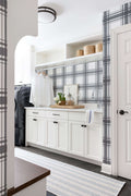 Mudroom with plaid wallpaper and a blue and ivory striped cotton runner