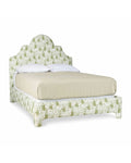 A queen-sized upholstered bed with a floral pattern on the headboard and footboard, in a beige color.