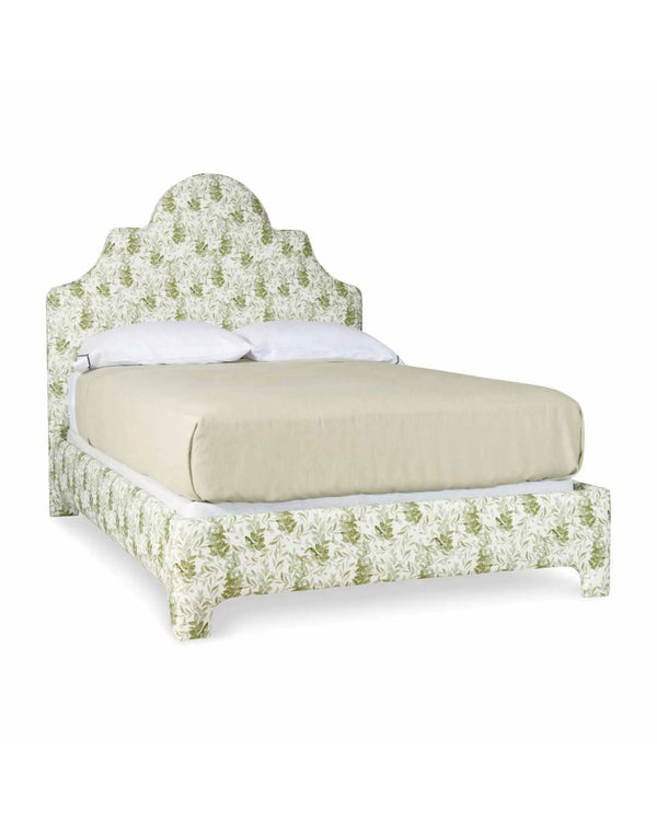 A queen-sized upholstered bed with a floral pattern on the headboard and footboard, in a beige color.