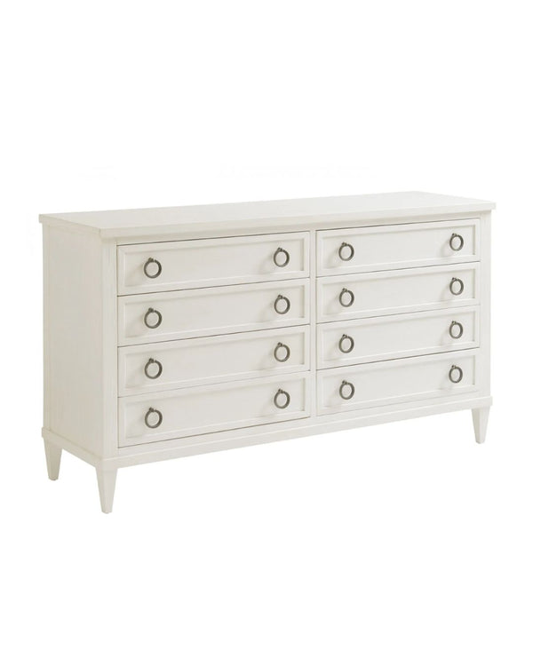 A white double dresser with eight drawers, featuring aged pewter hardware and tapered feet.