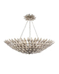A silver pendant light fixture with a wrought iron leaf design, suspended by a chain.