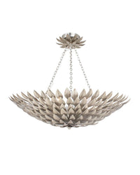 A silver pendant light fixture with a wrought iron leaf design, suspended by a chain.