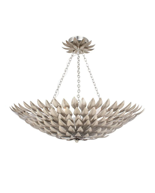 A silver pendant light fixture with a wrought iron leaf design, suspended by a chain.