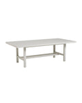 A rectangular dining table with a soft oyster-white finish on an aluminum frame, featuring a tabletop umbrella centerpiece.