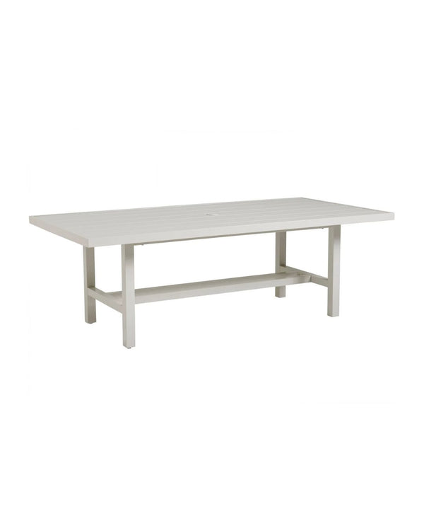 A rectangular dining table with a soft oyster-white finish on an aluminum frame, featuring a tabletop umbrella centerpiece.