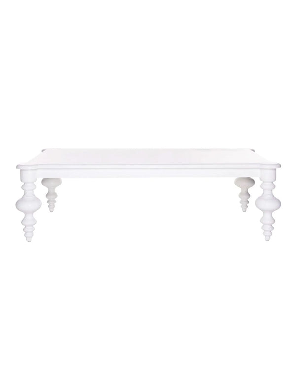A white rectangular coffee table with delicate, scroll-like legs and no visible storage compartments.